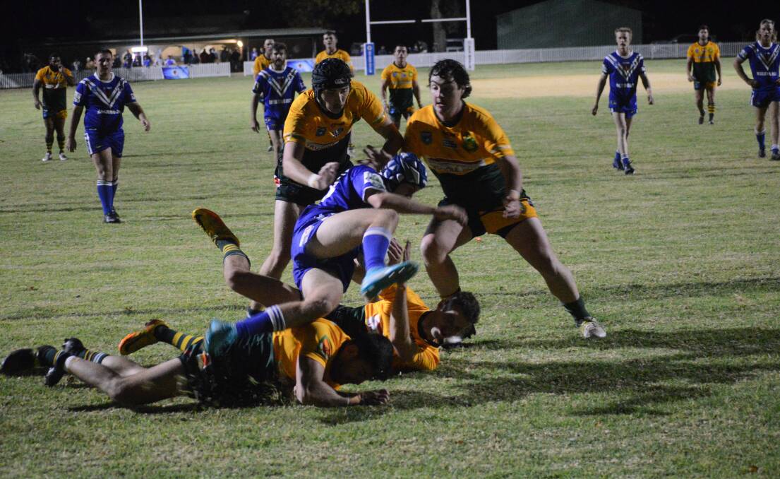 Trundle Boomers players converge on a Molong Bulls opponent in Round 3 of 2023. Picture by Riley Krause
