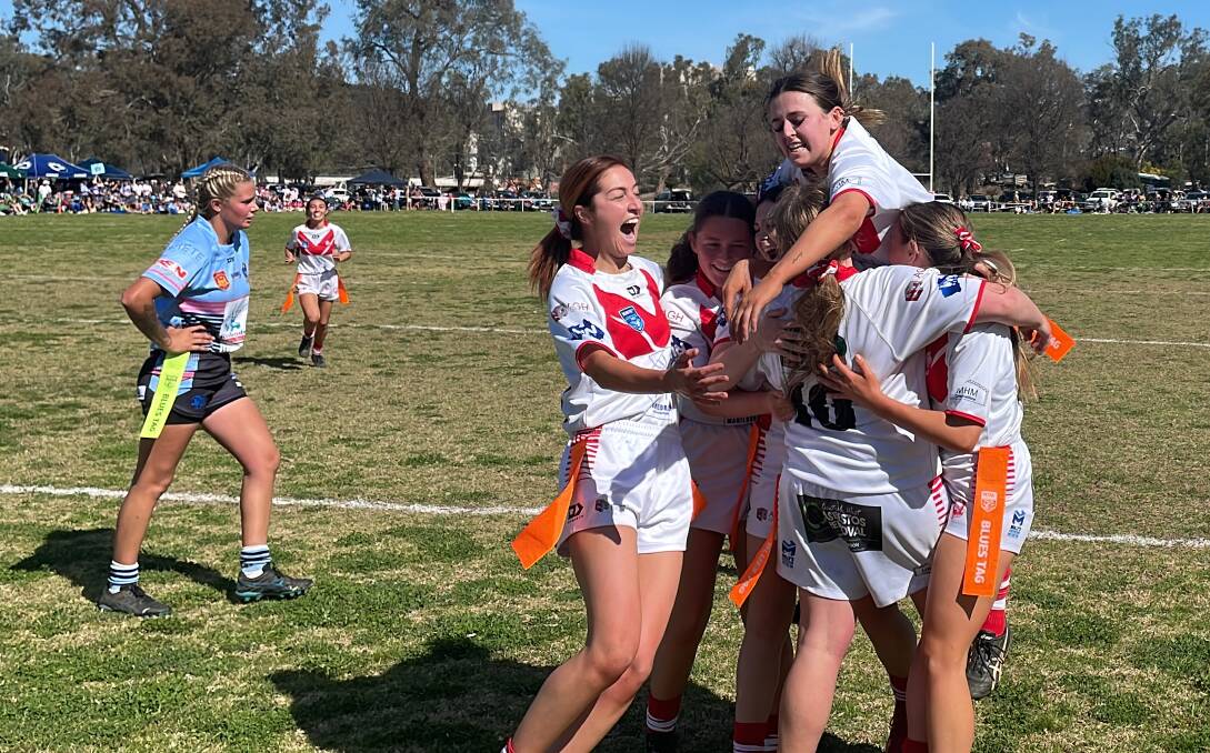 Manildra Rhinettes players celebrate Hayley Sharpless' try. Picture by Dominic Unwin