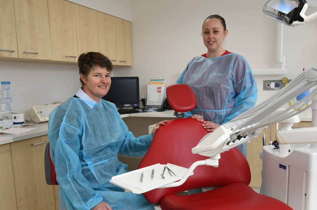 NEED TO BRUSH: Charles Sturt University’s dental and oral health clinic director Heather Cameron with her dental assistant Jess Gough. Photo: JUDE KEOGH 