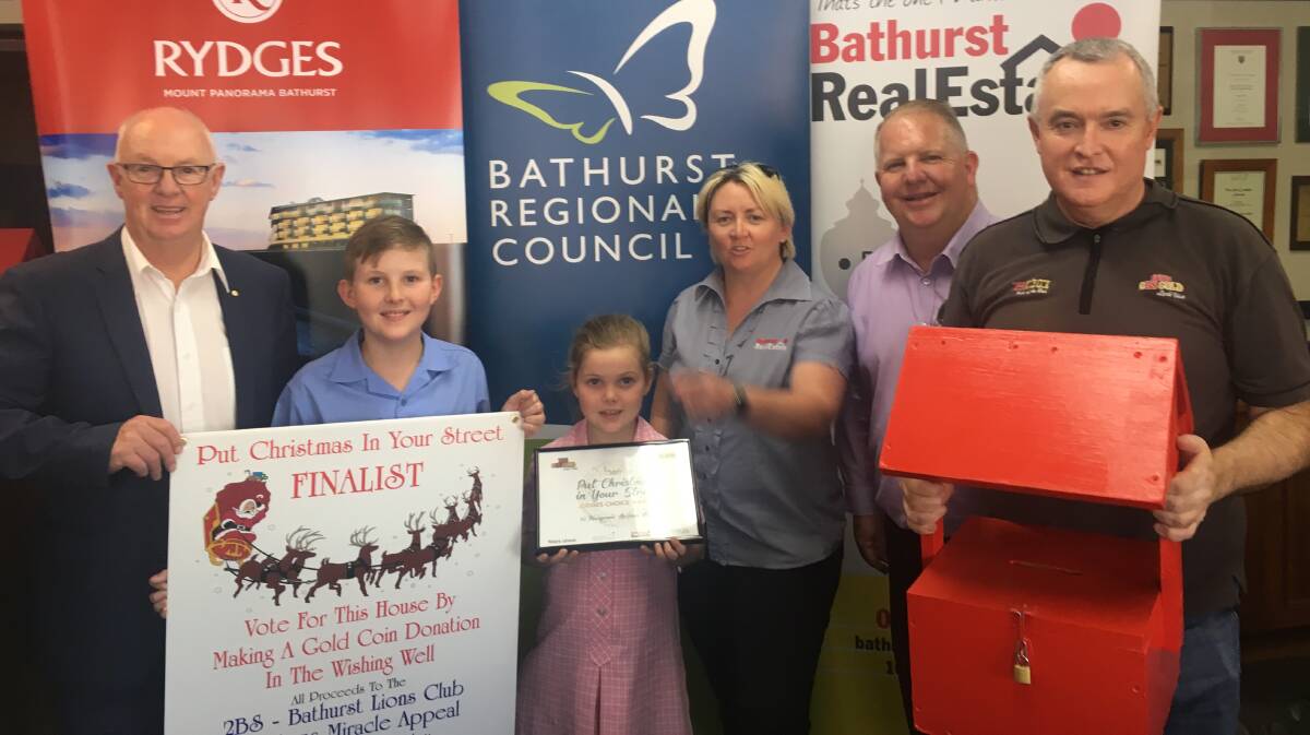 WINNER: Mayor Graeme Hanger, winners Jake and Piper Henry, Bathurst Real Estate's Stacey and Mick Whittaker and Bathurst Broadcasters general manager Phil Cole.
