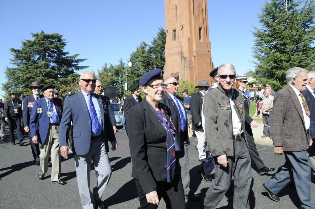 HONOURING: The Anzac Day Parade is see war veterans and their families march towards the Carillon for the 10.30am memorial service. Photo: CHRIS SEABROOK