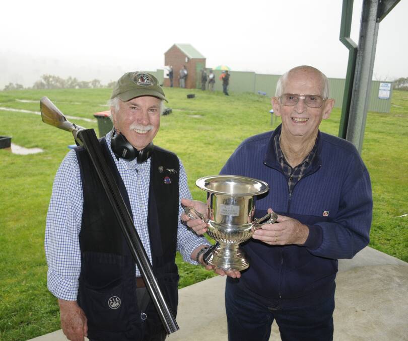 VICTORY: Last year's Side x Side Championships winner John Newton and retired Bathurst Clay Target Club president Les Aberley. Photo: CHRIS SEABROOK