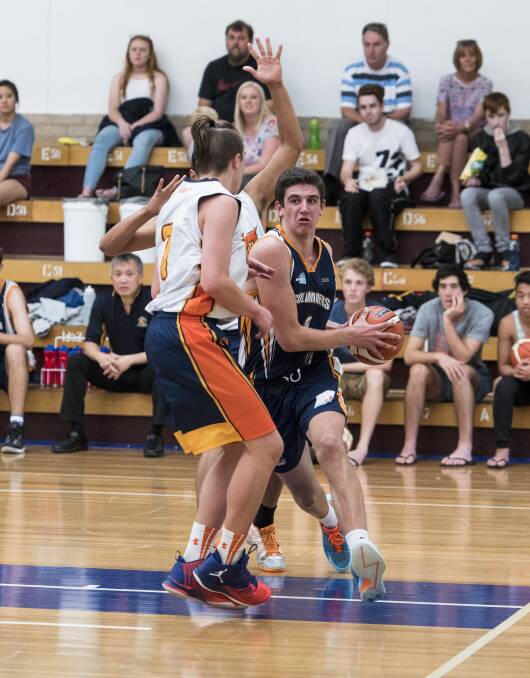 HOT FORM: Bathurst Goldminers' Matt Gray (pictured, with ball) top scored with 29 points against the Sydney Comets. Photo: ALEXANDER GRANT