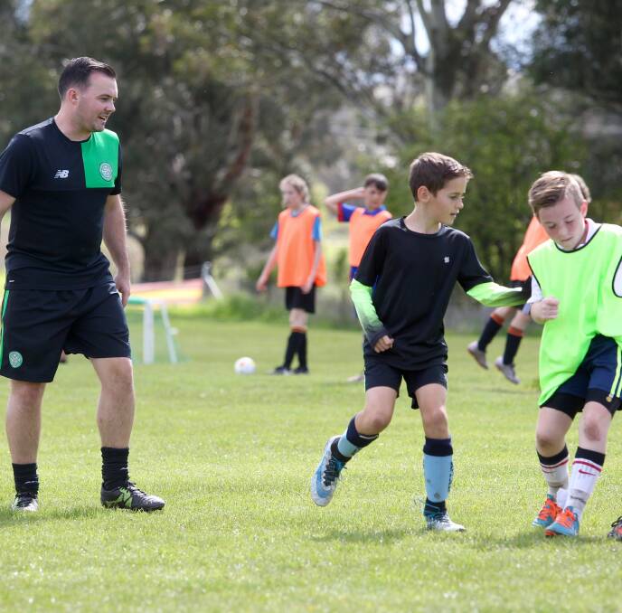 BHOYS: Docherty runs some young soccer players through their paces. 092416pbcelt7