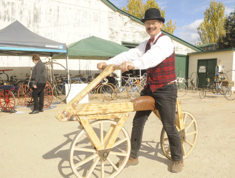 RELIC: Bicycle enthusiast John Kitchen on a replica, which he made, of the first bicycle made by German Baron Karl von Drais in 1817. 051417ctrail10