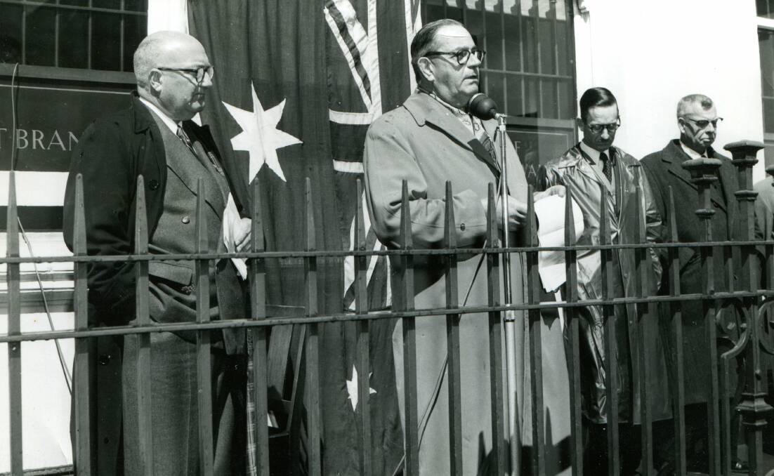 BIG OCCASION: Bathurst branch manager A.W. Clarke at the microphone during the unveiling of a plaque out the front of the Bank of New South Wales in 1956.