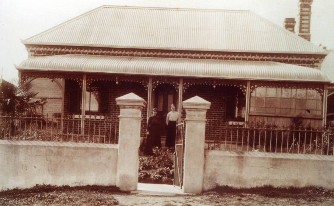 HOUSE AND HOME: George Haywood's home, pictured with two children out the front, remains in Kelso.