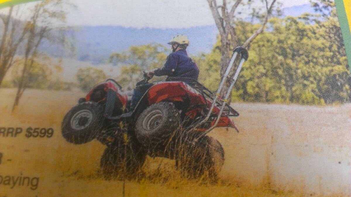 RISKY BUSINESS: This ATV rider is riding at close to the point of balance. Note his safety helmet and rollover bar.