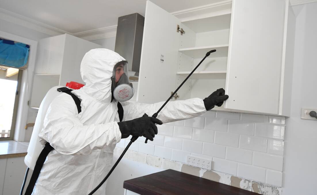 CONTAMINATION CHECK: Daniel Taurins inspects a house in Orange for residue chemicals from potential drug use, a practice that is becoming more common across the country. Photo: JUDE KEOGH 0530jkmeth7