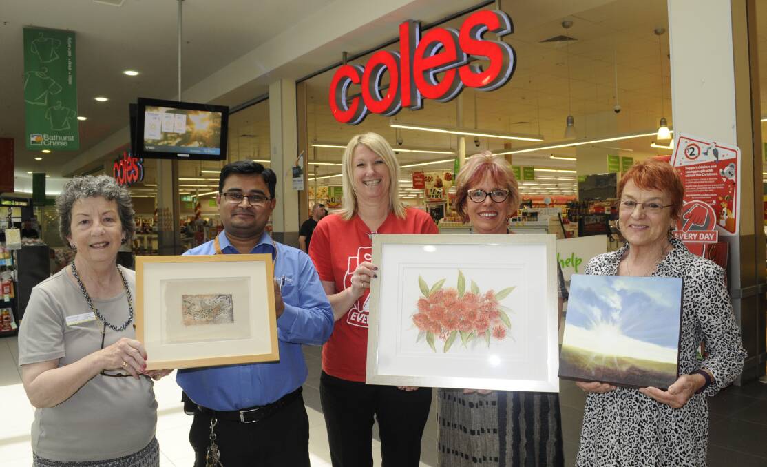 RAFFLE DRAW: Daffodil Cottage fundraising co-ordinator Jane Rawlings, Ishaq from Bathurst Chase, Coles' Glenys Charlton, Heather Dunn of t.arts Gallery and Merilyn Rice. Photo: CHRIS SEABROOK 112816craffle2