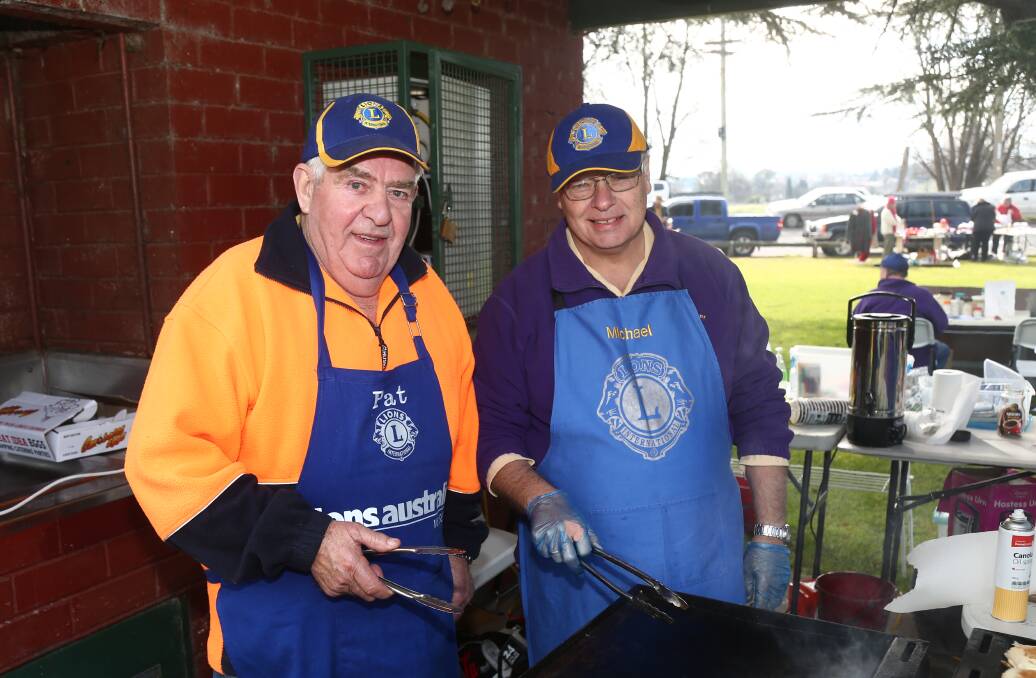SMELLS GOOD: Pat Duff and Michael Ryan had some sausages sizzling at the markets. 080616pblions10