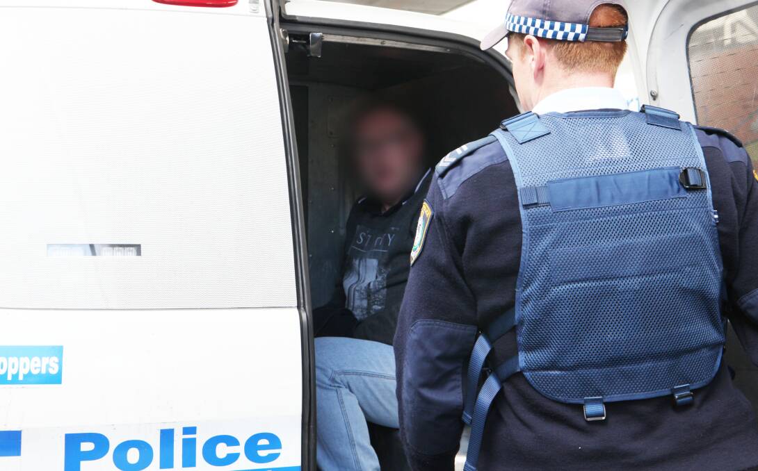 CHARGES: NSW Police with one of the accused at Sydney airport last Wednesday. Photo: NSW Police