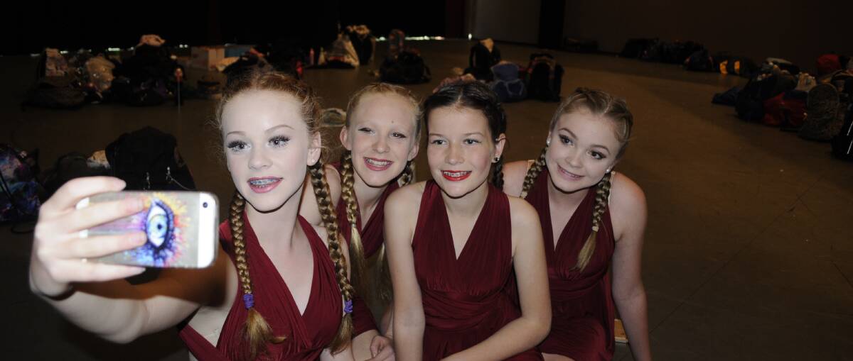 LET’S DANCE: Denison College Bathurst campus students Lily Cole, Finella McBurney, Elise Fowler and Lucinda Begg take a selfie backstage before performing as part of the Western NSW Dance Festival at Bathurst Memorial Entertainment Centre yesterday. Photo: CHRIS SEABROOK	 061516cdfest1