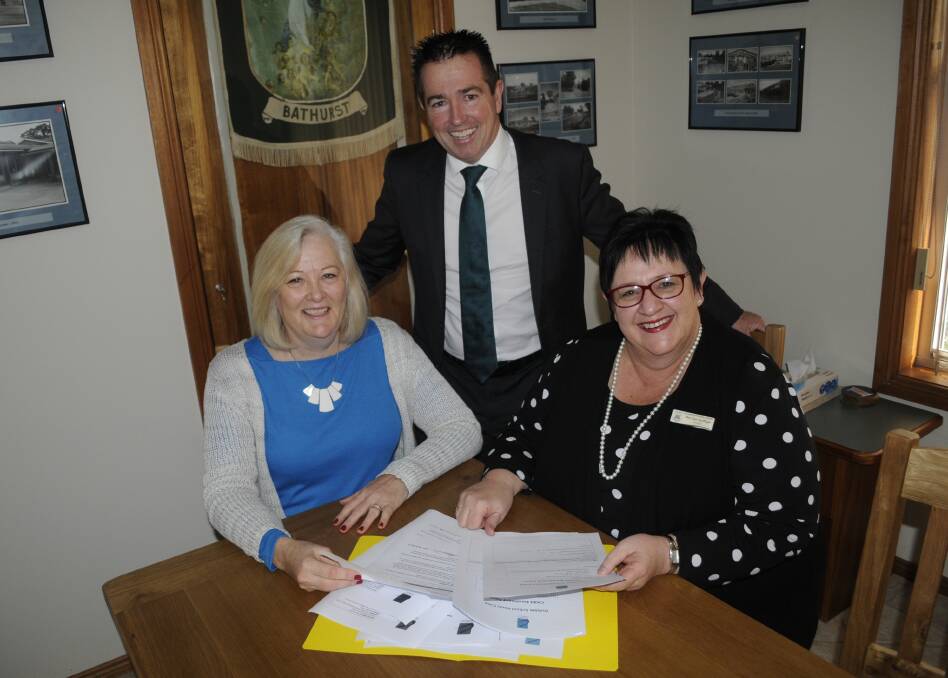 WORKING TOGETHER: OSHC co-ordinator Karen Wilkie, Member for Bathurst Paul Toole and Assumption School principal Sue Guilfoyle discuss plans for the new out of school hours care service. Photo: CHRIS SEABROOK	 062016care