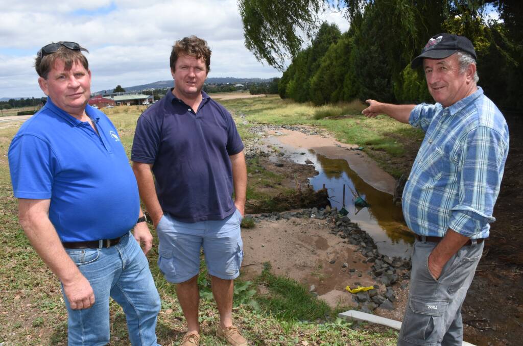 CONCERN: Stephen Hill, Liam O'Hara and councillor Bobby Bourke after the flooding in Leo Grant Drive earlier this month. Photo: NADINE MORTON
