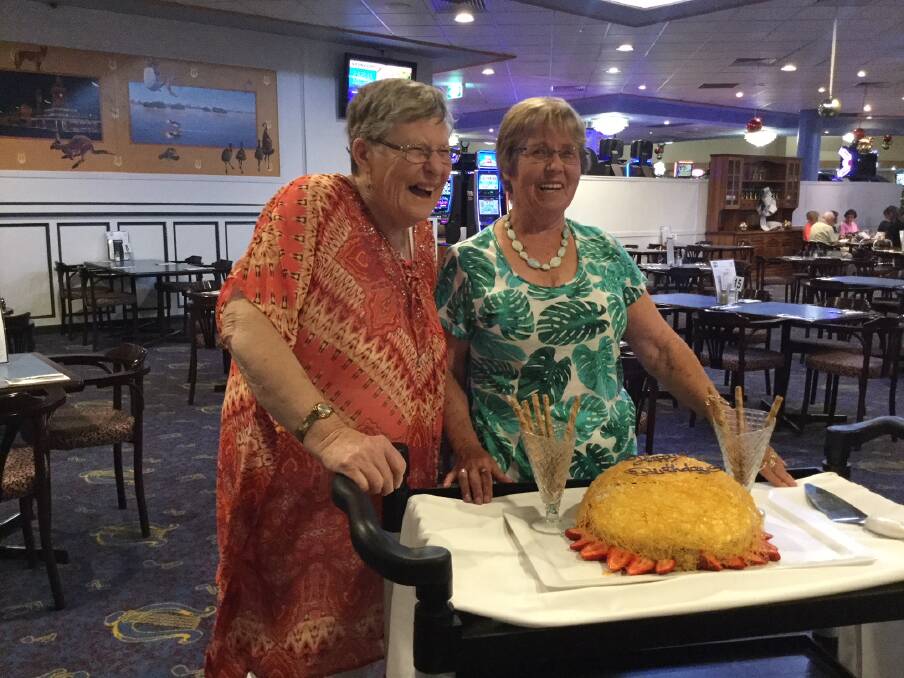 SPECIAL OCCASION: Margaret Stephen and Elaine Anderson cut their birthday cake at the Musicians' Club.