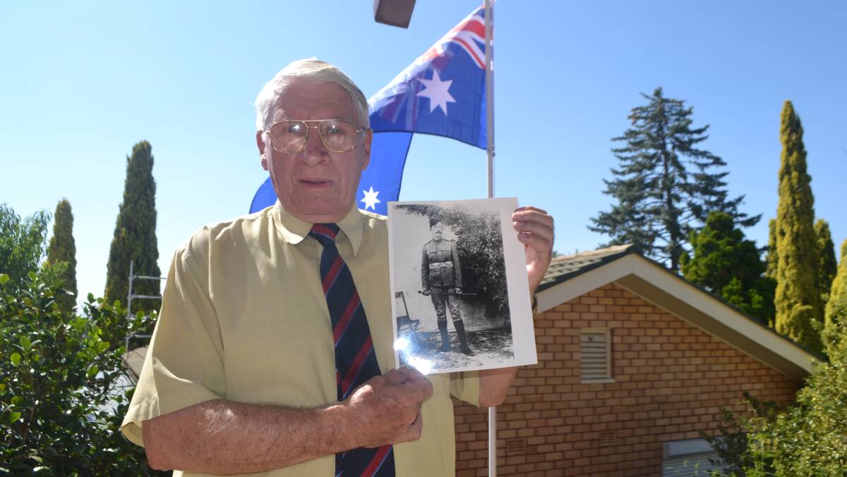 HISTORY'S PAGE: Bathurst war historian Denis Chamberlain with a photo of Peter Handcock, who was executed for war crimes in 1902 during the Boer War - a decision that remains controversial to this day. Photo: BRADLEY JURD