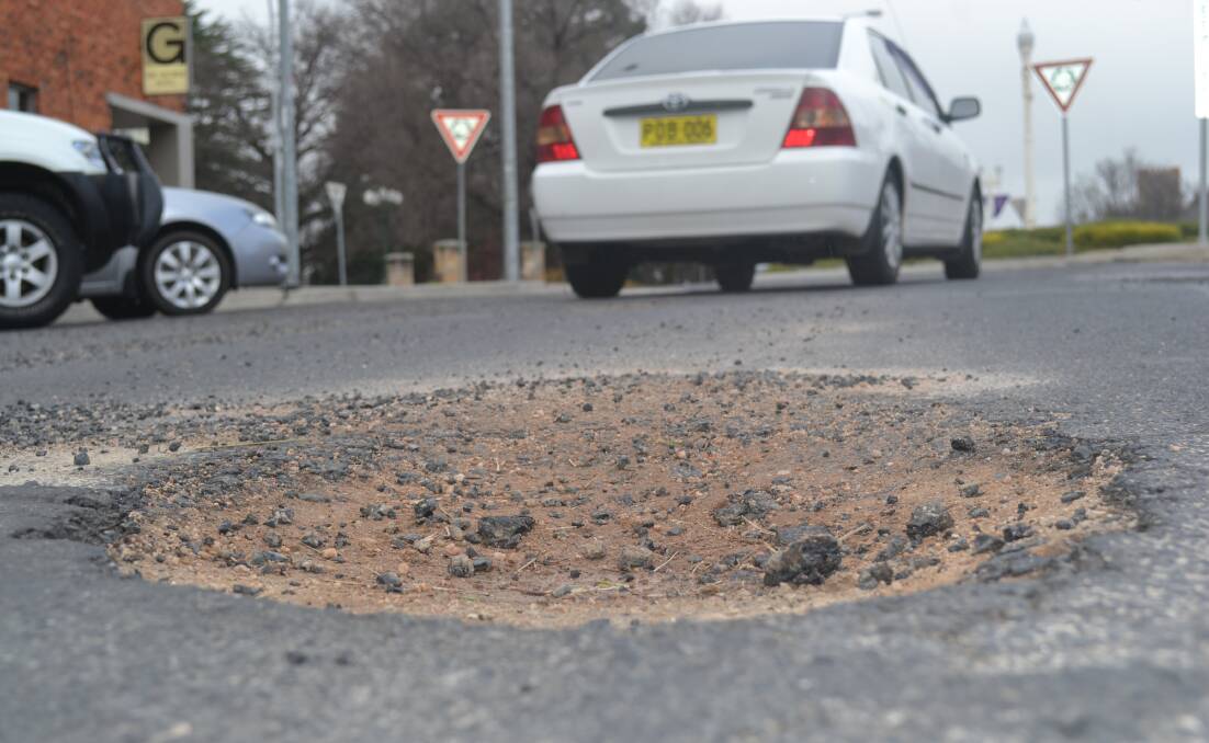 OUCH: Potholes are emerging across the local road network as the big wet of recent weeks starts to take a toll. This example of the damage being caused is near the George Hotel on the corner of Keppel and George streets. 	062216bwpot