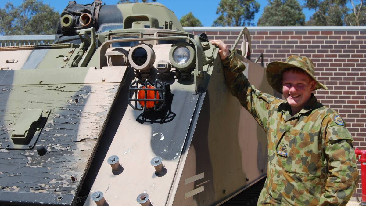 LEARNING: CDTWO2 Joshua Van Essen, 17, from the Scots School Army Cadet Unit, alongside an armoured personnel carrier at the Australian Army Infantry Museum at Singleton.