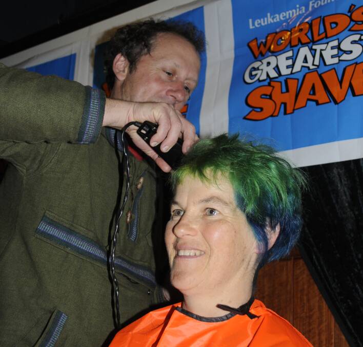 THERE IT GOES: Glen Lewin shaves his wife Kirsty's hair off for the big fundraiser. 090416cshave5