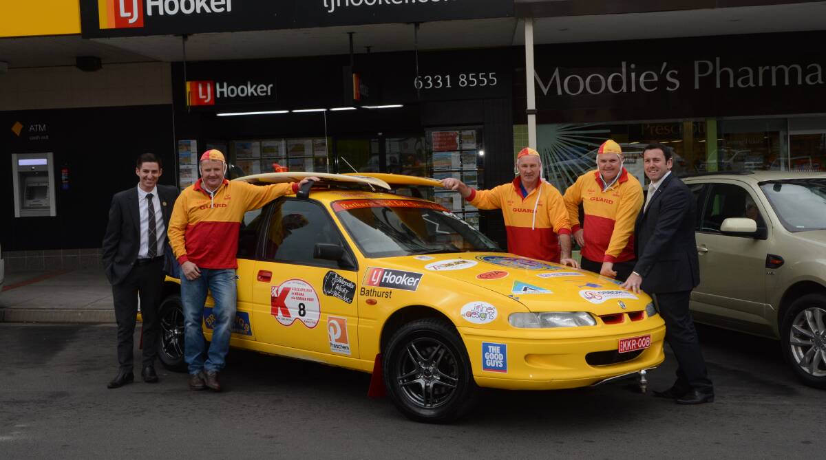 BIG ADVENTURE: Zac Theobald (left) and David Chapman (right) of LJ Hooker with Bathurst Surf Lifesaving Club members Graham Ward, Richie Farrar and Peter Ward ahead of last year’s Kidney Kar Rally. A dinner dance on Saturday will help raise money for this year's rally. 	080515phooker