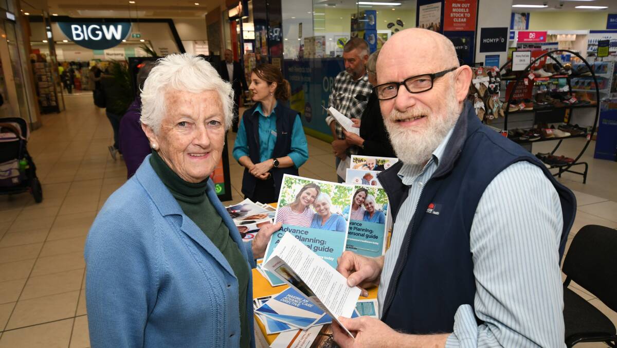 QUESTIONS AND ANSWERS: Pat McDonald talks with palliative care nurse consultant James Daley during an information session in the Bathurst CBD on Tuesday. Photo: CHRIS SEABROOK 080619cinfoday1