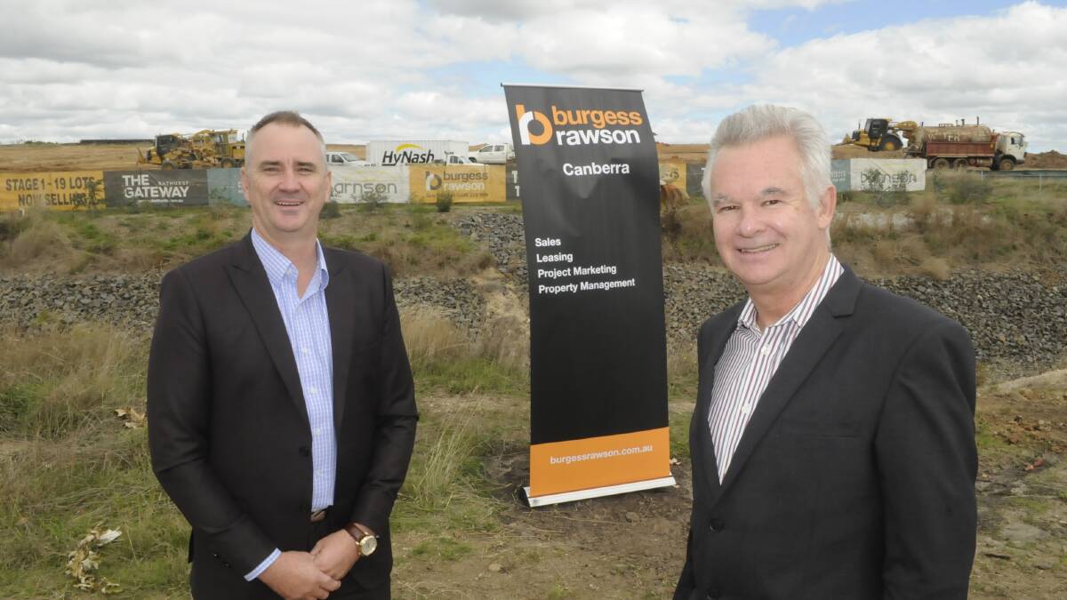 GOING AHEAD: Burgess Rawson's Guy Randell and Gateway Land Corporation development director Bob Walsh at the development site at Kelso. Photo: CHRIS SEABROOK 040517cgatewy1