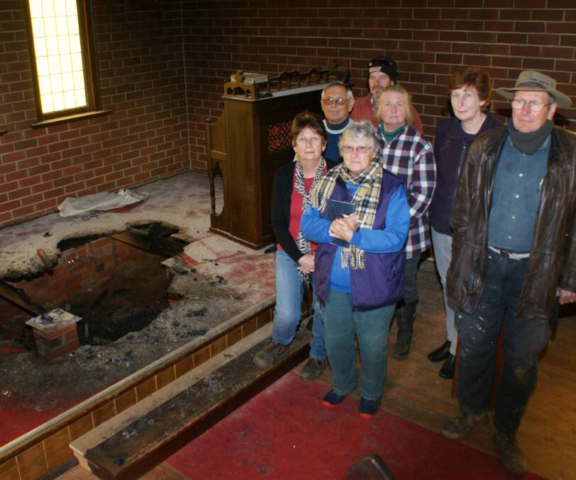 ANGER: Hobbys Yards residents Kerry Cook, Don Young, Judy Belecky, Hugh Brown, Janet Sutherland, Robynne Kelly and Franz Belecky in the damaged church.