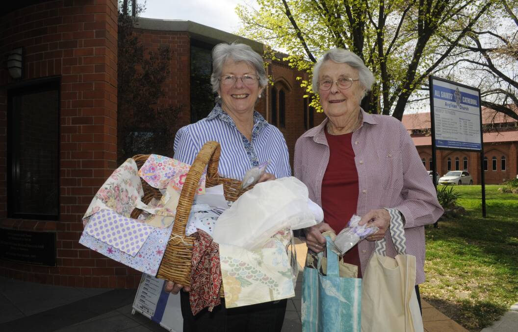 BAG IT: Christine Hurford and Lalage Gabb holding environmentally friendly bags for the All Saints' Cathedral Spring Fair. Photo: CHRIS SEABROOK 101717crecycle1