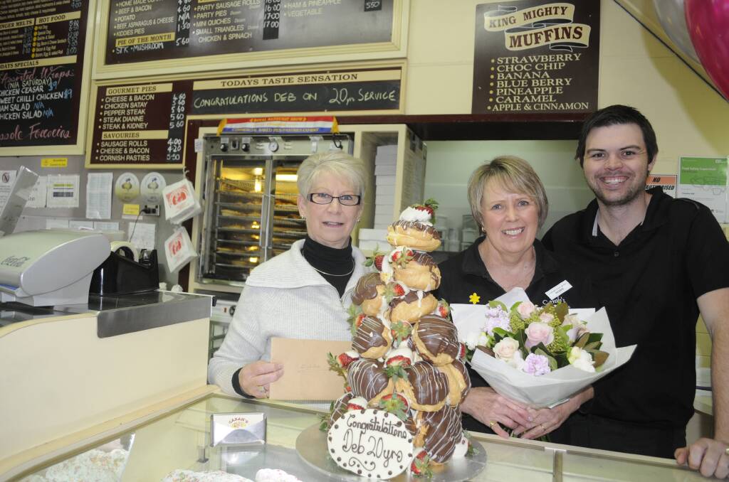 BIG OCCASION: Colleen Carah and Nathan King helped Debbie Gillman (centre) celebrate her 20 years with the business on Monday morning. Photo: CHRIS SEABROOK 082117cdeb20