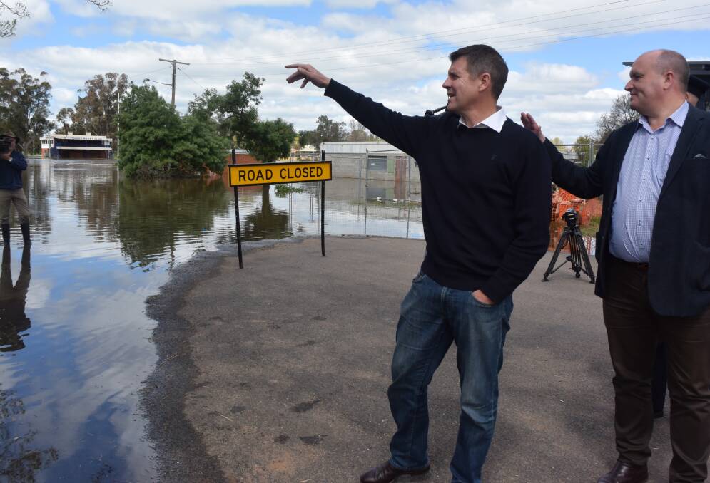 SUPPORT: NSW Premier Mike Baird assesses flood damage in Forbes on Monday with Minister for Emergency Services David Elliott.