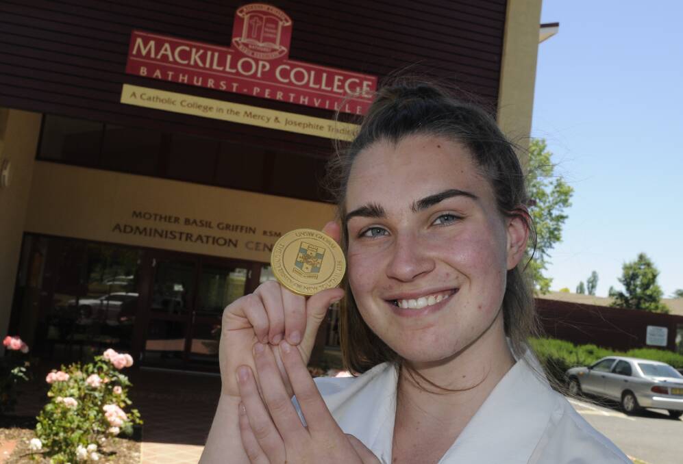 RIGHT WORDS: MacKillop College year 10 student Kate King-Smith with her medal from the International Competitions and Assessments for Schools. Photo:CHRIS SEABROOK 112916cmedal