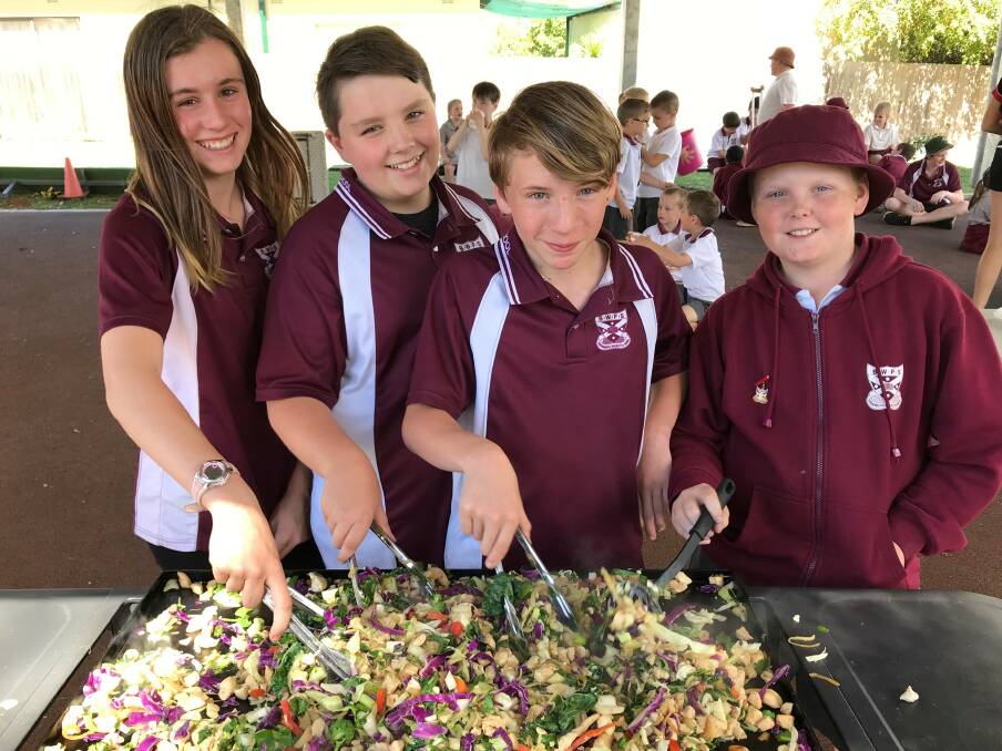 ON THE MENU: Bathurst West Public School students Isabelle, Brodie, Nathan and Robert prepare a healthy chicken stir fry made from fresh organic produce from the school's vegetable garden.