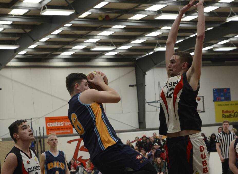 JUST THE SHOT: Bathurst High's James Eggins encounters some tall timber as he attempts a shot during Wednesday's Astley Cup loss to Dubbo. Photo: PHILL MURRAY 062916pbball2