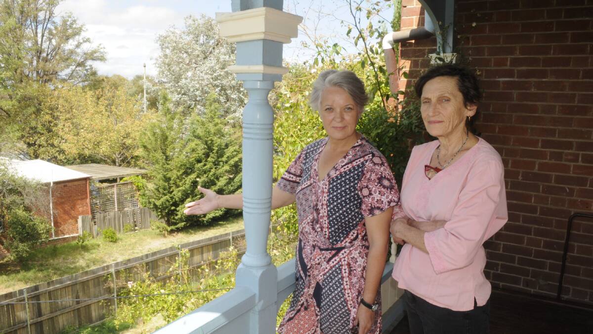 BIG CONCERN: Neighbours Suzanne Ryan and Margaret Ling looking over the small block where an ultra-modern home will be built between their two 1800s houses.