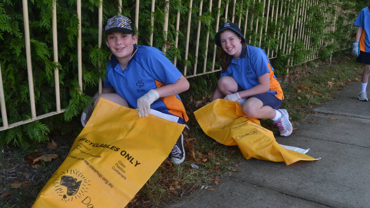 WHAT A LOAD OF RUBBISH: Hannah Gilbert and Isabelle Baird cleaning along Durham Street as part of last year's Clean Up Australia Day.