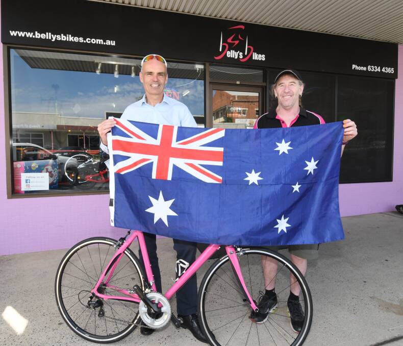 NOW: Simon King, from Cirencester, England, with Belly's Bikes owner Greg Bell. Photo: CHRIS SEABROOK 031218cflag