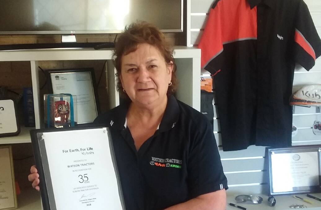 RECOGNISED: Millie Watson proudly displays her Kubota plaque for 35 years of service by Watson Tractors Bathurst.