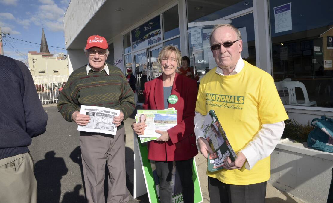 ROLL UP: Party supporters Steve Howes (Labor), Elizabeth Barrett (Greens) and David Veness (Nationals) handing out how to vote flyers at Bathurst’s pre-polling booth yesterday. Photo: PHILL MURRAY 	061416pvote