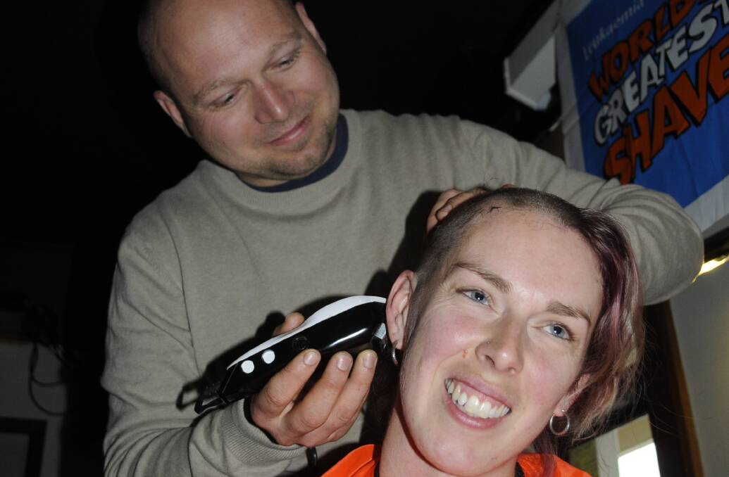 HAIR TODAY: Josh Wright shaves his wife Bronwyn's hair off for the fundraiser. 090416cshave2