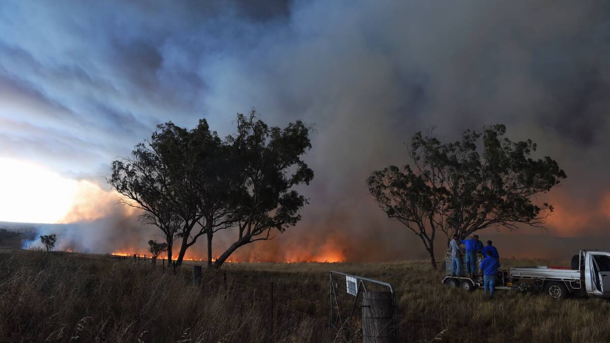 HELLISH: Bathurst district firefighters joined the battle against blazes near Mudgee on Monday. The fires began on the weekend during extreme heat in the state. Photo: NICK MOIR