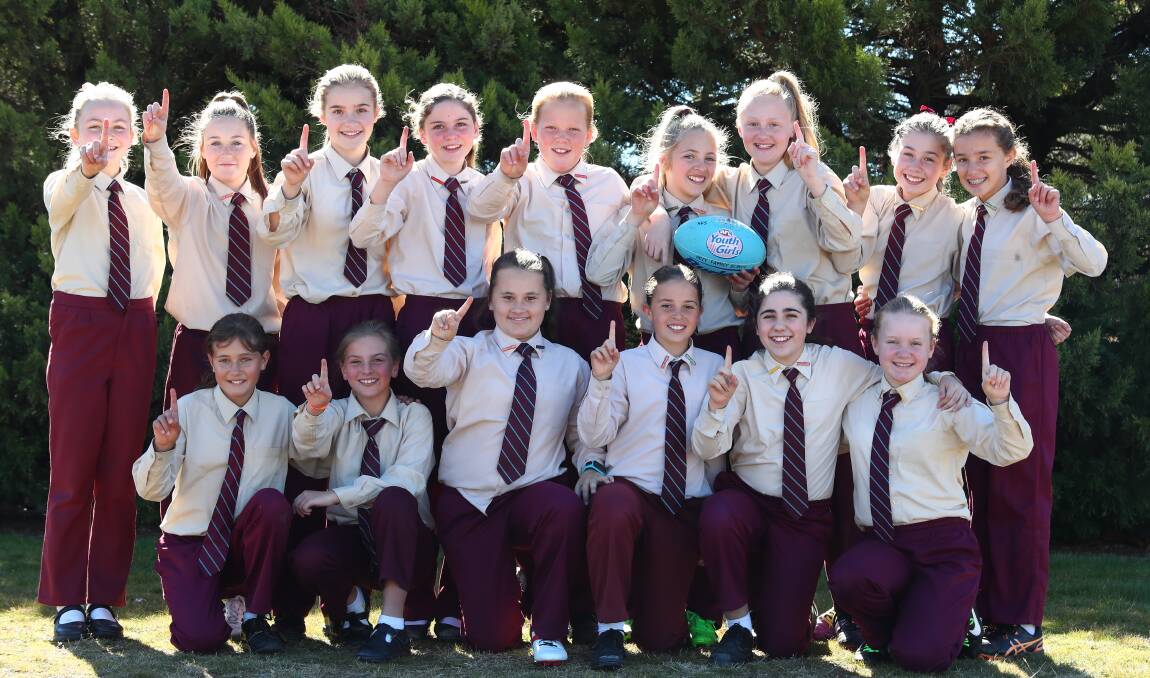 CHALLENGE: The Holy Family School years five/six girls' Aussie rules team will compete in the state finals of the Paul Kelly Cup. Photo: PHIL BLATCH