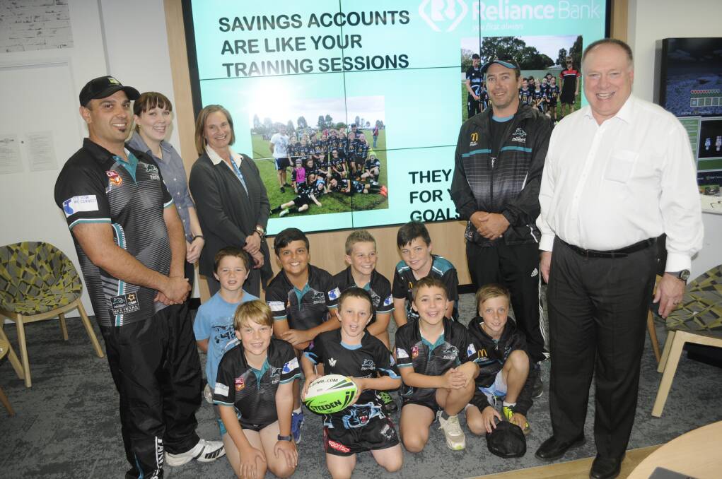 DOLLARS AND SENSE: Harry Saban (left) and Jeffrey Hudson (second from right) of the Bathurst Panthers Junior Rugby League with Sarah Kunst of Gunthers Lane, Erika King-Smith and Clinton Blanks of Reliance Bank and the Panthers under 10s players. Photo: CHRIS SEABROOK 040417cu10span