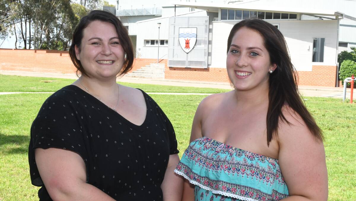 BY DEGREES: CSU graduates Katreena Shelley, of Rylstone, and Amelia Bernasconi, of Scone, feel confident in taking on the world of journalism. Photo: CHRIS SEABROOK 121317csugrads1