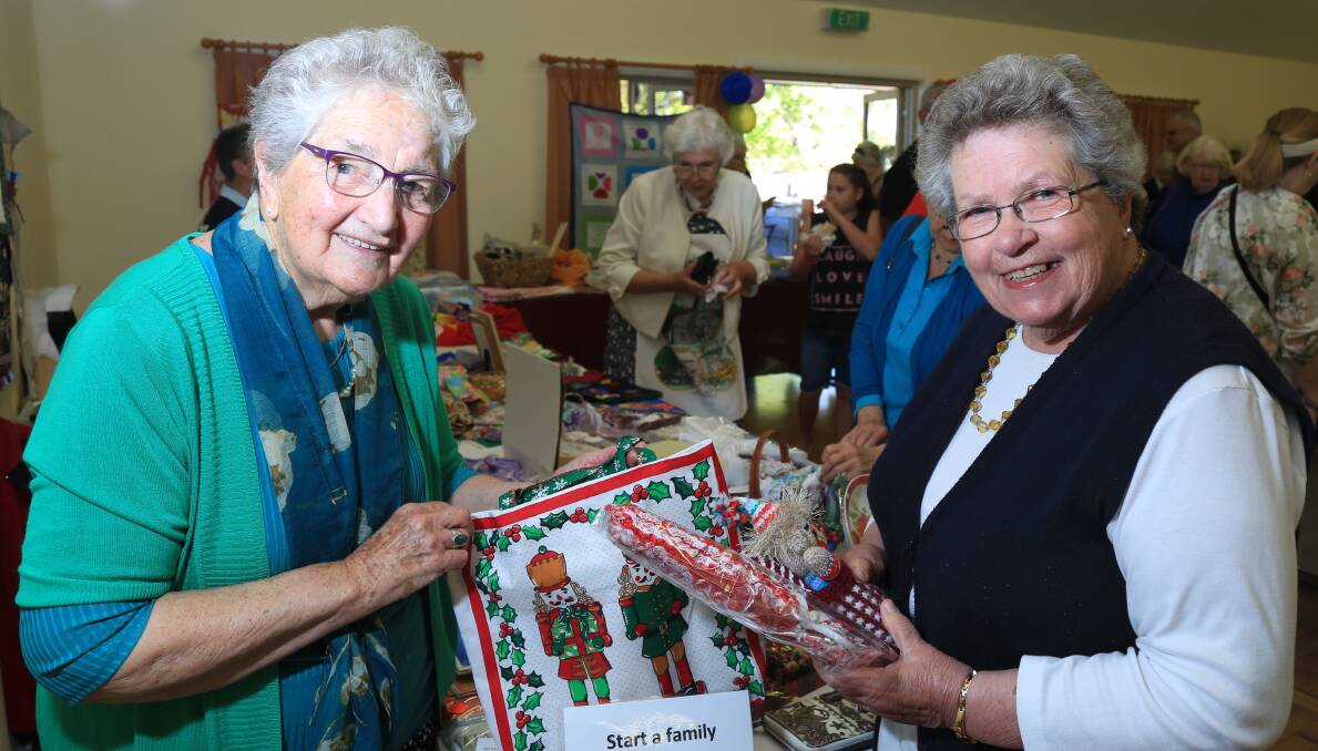 BIT OF A LOOK: Audrey Shoobridge and Eva Harrison having a look at some of the items at the fair. 101516pbtrinity7