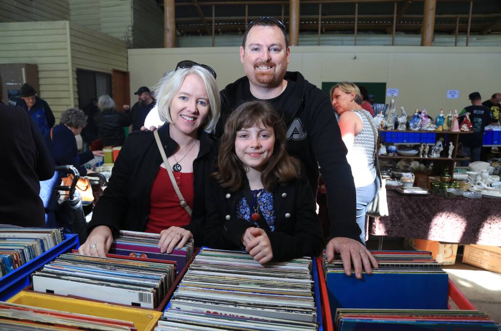 RIGHT NOTE: Leanne, Caitlyn and Alan Poll were among the crowds who searched through dozens of boxes full of records last year. The record fair will return to the Bathurst Showground from 9am on Sunday. Photo: PHIL BLATCH 101516pbvintage4