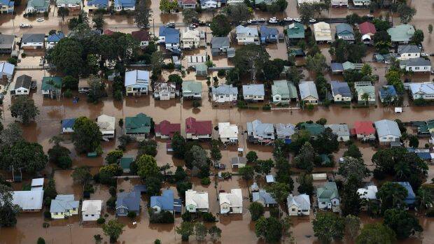 An aerial photograph of floodwaters engulfing homes in central Lismore. Photo: AAP