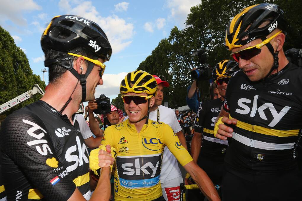 Chris Froome of Great Britain and Team Sky is congratulated by Wouter Poels of the Netherlands and Team Sky (L) and Ian Stannard of Great Britain and Team Sky (R) after crossing the finishing line during stage twenty one of the 2016 Le Tour de France, from Chantilly to Paris Champs-Elysees on July 24, 2016 in Paris, France. (Photo by Michael Steele/Getty Images)
