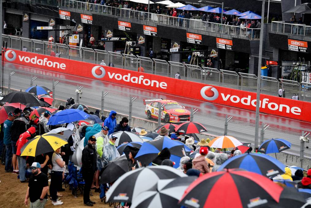 V8 Supercar fans in the wet conditions during the Bathurst 1000 at Mount Panorama, Bathurst. Photo: AAP Image/Brendan Esposito