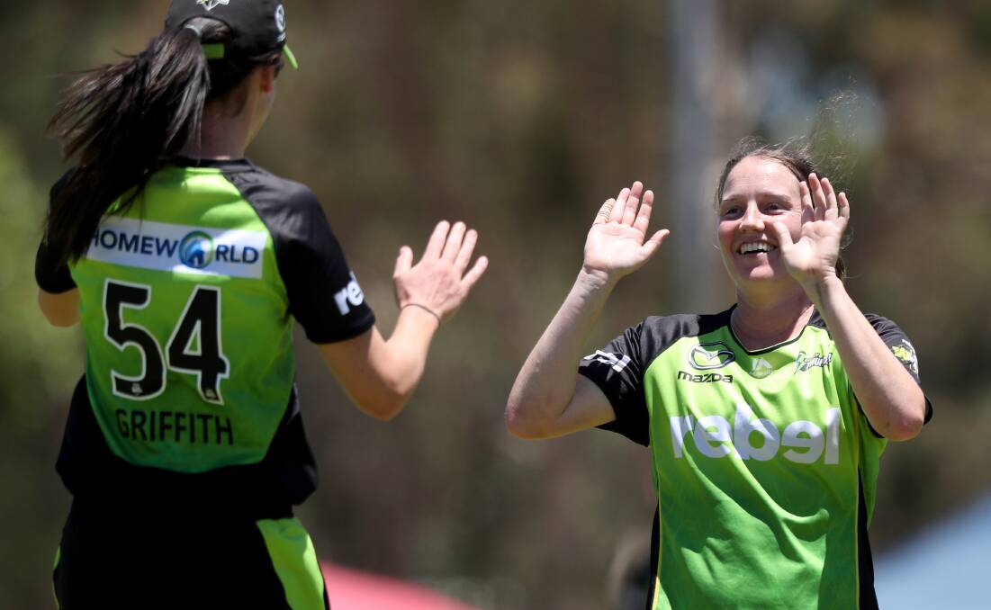 YOU BEAUTY: Bathurst's Lisa Griffith congratulates Thunder team-mate Rene Farrell after taking a catch off her bowling. Photo: AAP